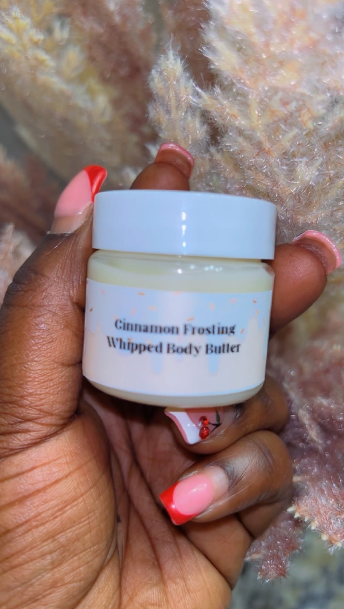 ravel-size Cinnamon Frosting Body Butter, nourishing whipped formula in a small clear jar with white lid